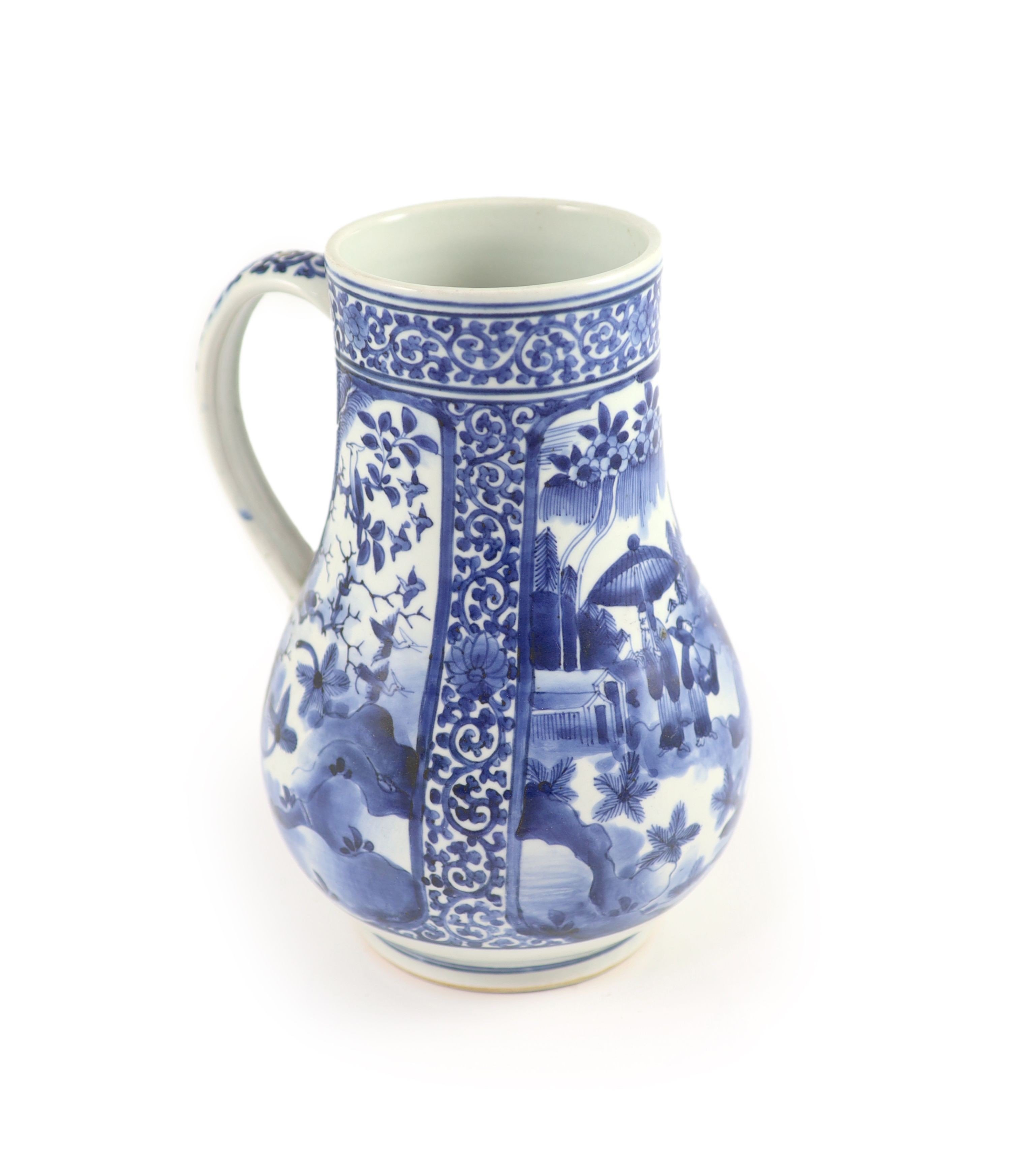 A Japanese Arita blue and white tankard, c.1700, 23.8 cm high